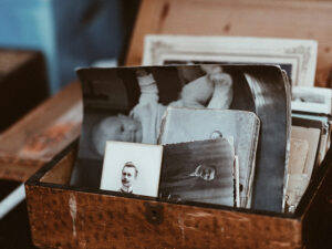 A wooden box filled with photos and other items.
